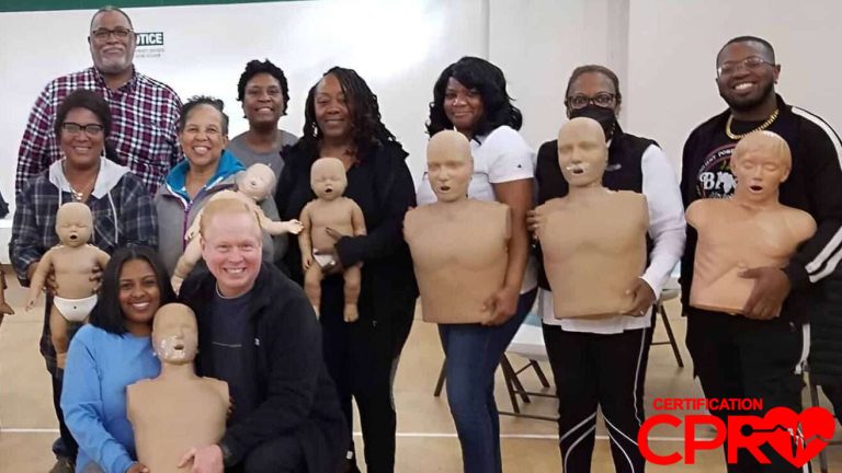 Group CPR training session in Baltimore with mannequins for certification.