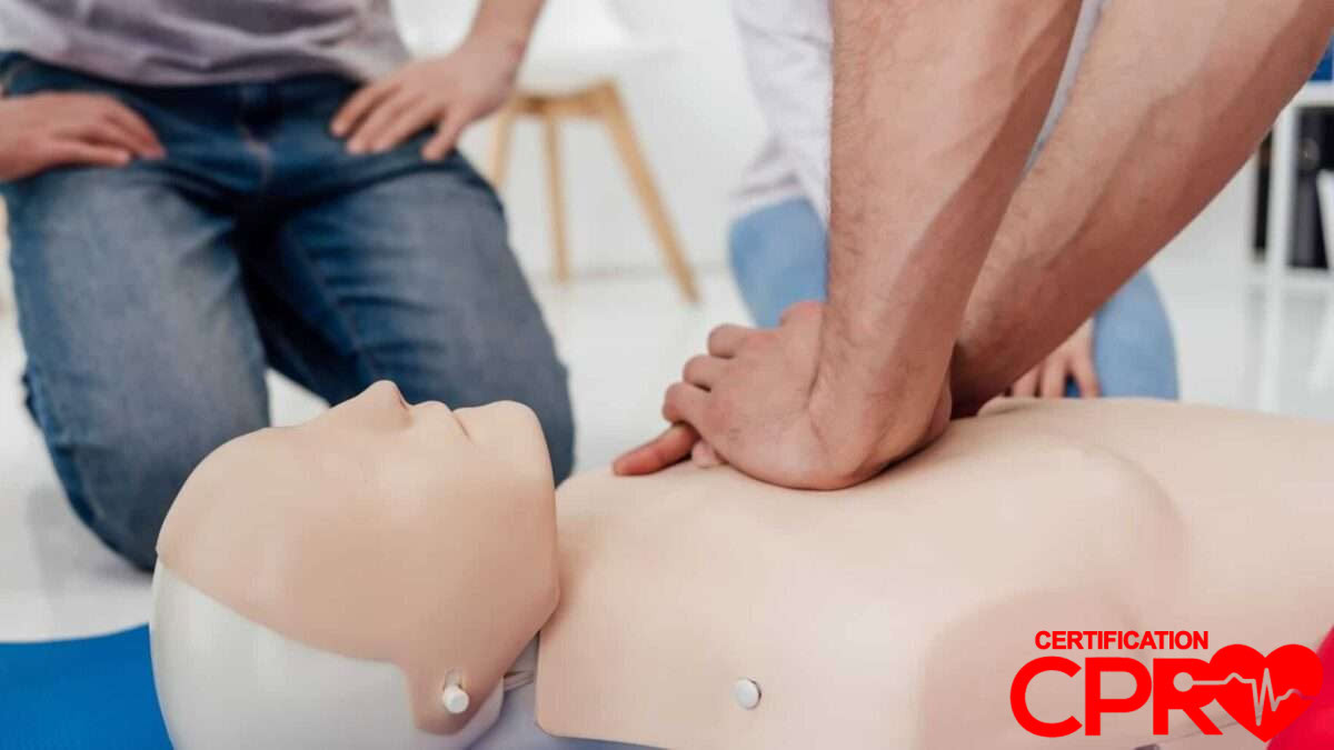 CPR training session with a man practicing on a mannequin in Baltimore.